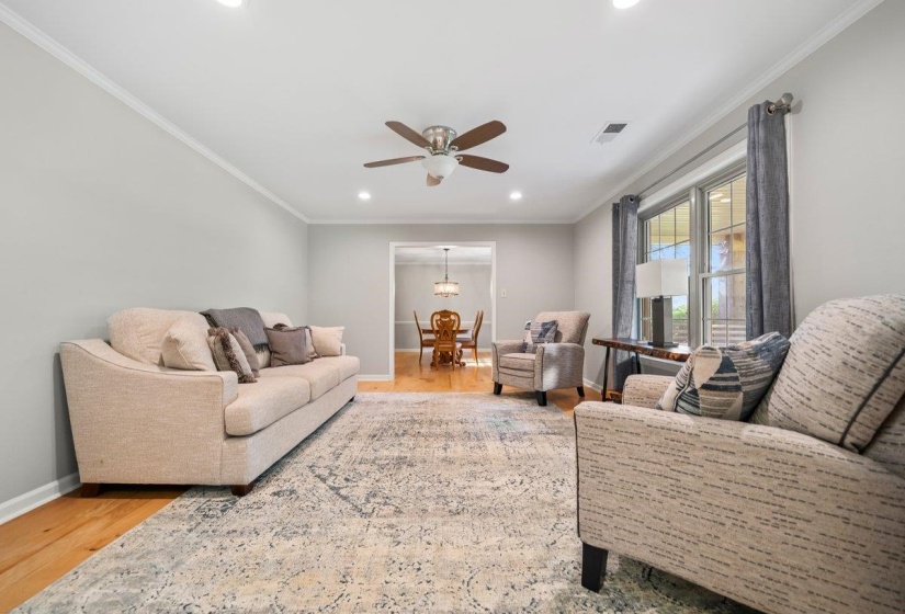 Living area featuring wood-finish flooring, recessed lighting, and a ceiling fan
