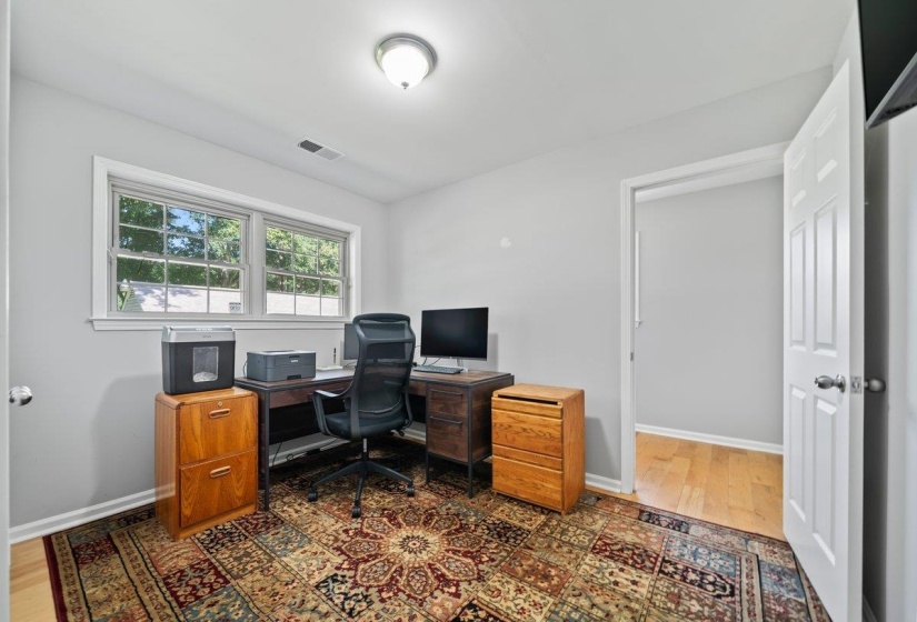 Office with windows and large closet