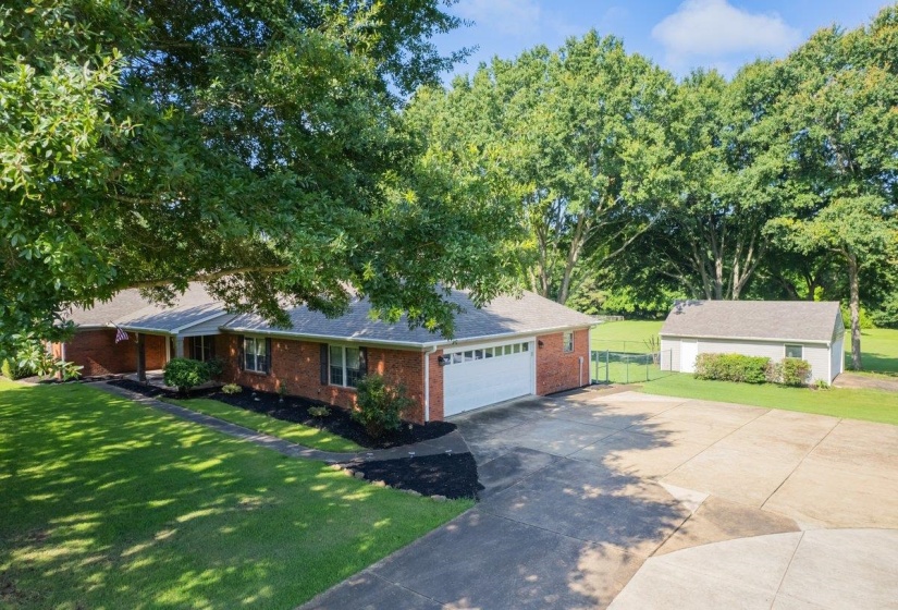Brick exterior with a covered front porch and an attached two-car garage