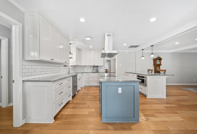 Updated Bright kitchen featuring white cabinetry, tile backsplash