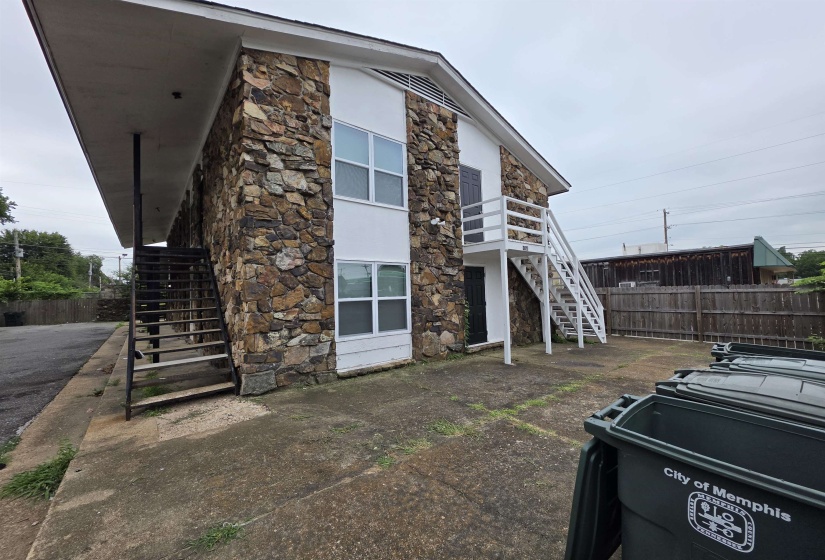 Two-story building featuring stone veneer siding and white painted trim