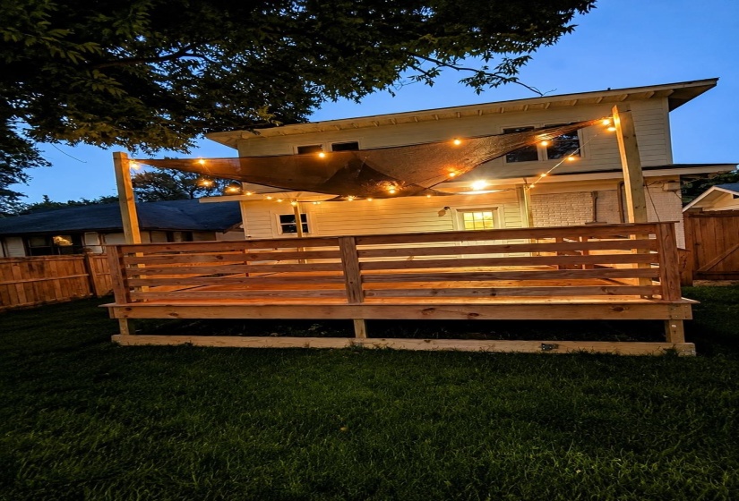 Expansive outdoor deck featuring wood construction and a slatted railing
