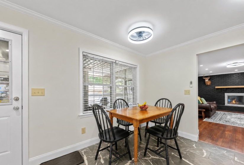 Cozy breakfast area overlooking the screened porch, offering the perfect spot for casual meals, morning coffee, or gathering.