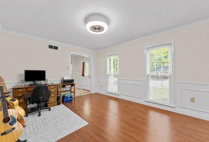 Bright dining room with large windows, abundant natural light, and a versatile layout that can easily accommodate formal dining or a stylish home office.