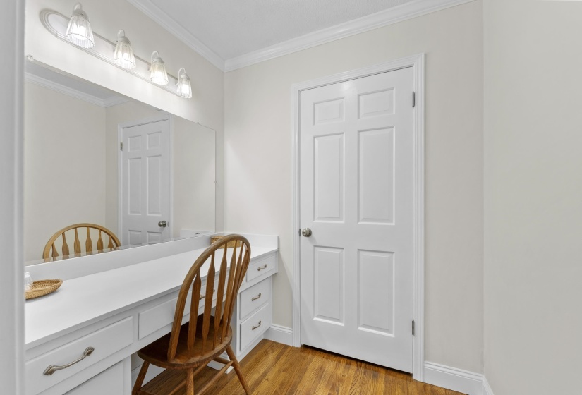 Separate vanity and dressing area provides additional storage and convenience, making busy mornings a breeze.