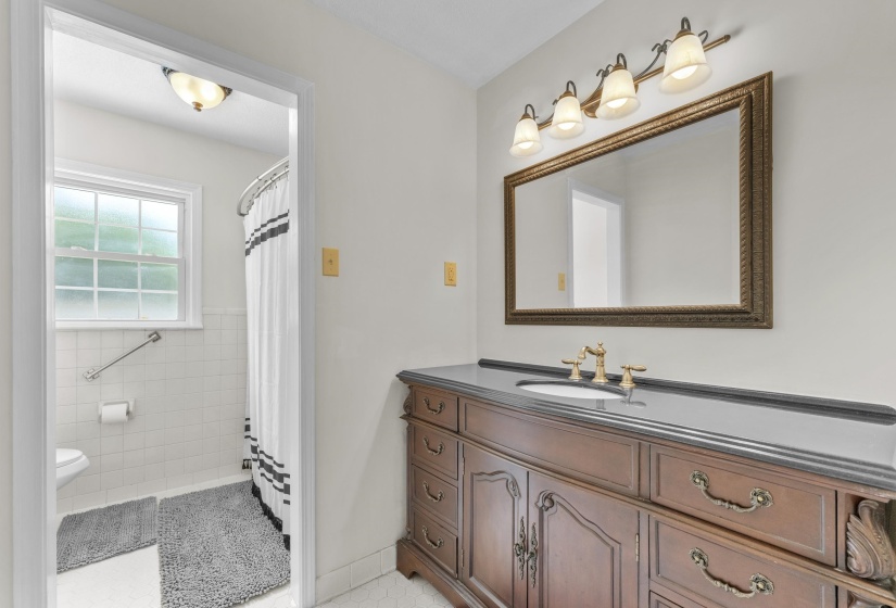 Convenient full bathroom with updated vanity, fresh finishes, and a tub/shower combination serving secondary bedrooms and guests.