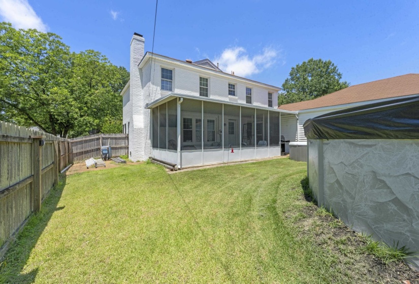 Spacious backyard featuring a screened porch, and plenty of room for outdoor entertaining.