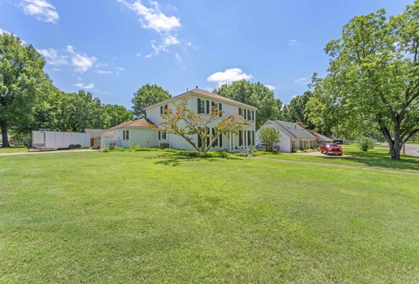 Beautiful curb appeal with mature trees, expansive lawn space, and timeless architectural design.