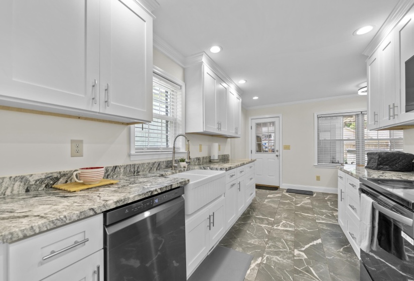 Thoughtfully redesigned kitchen with extensive counter space, updated cabinetry, and a functional layout ideal for meal preparation and entertaining.