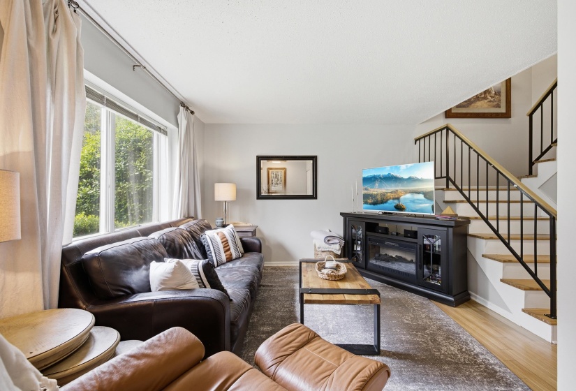 The Great Room has a lot of light and overlooks the grassy area out front.