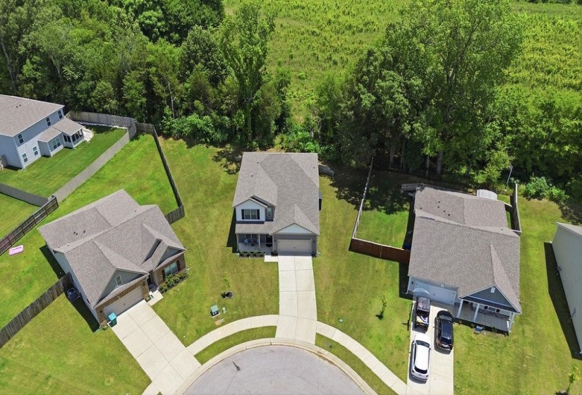 Centrally positioned residence with a front-facing garage and a concrete driveway