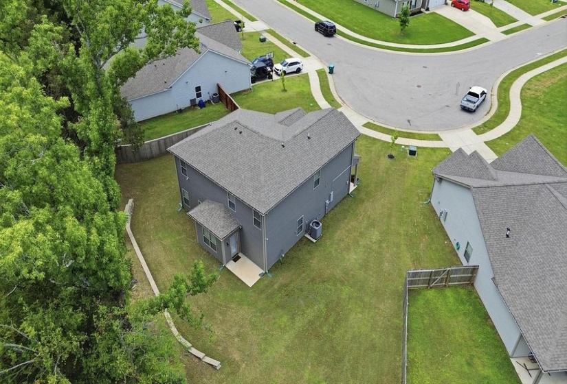 Two-story residential property featuring a gray exterior siding and a dark shingle roof