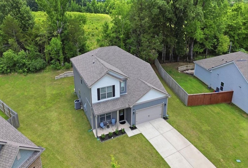 Two-story residence featuring a light gray exterior with white trim accents and a dark gray shingle roof