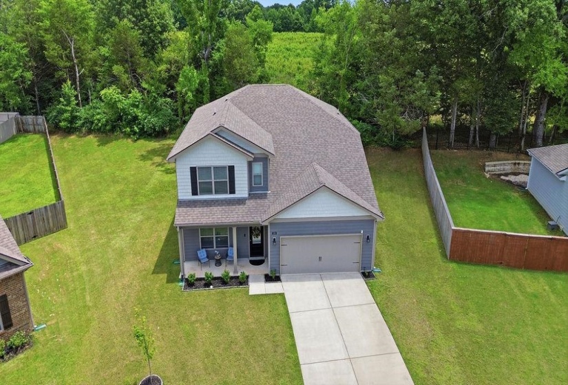 Two-story residence featuring a covered front porch, an attached two-car garage, and a concrete driveway