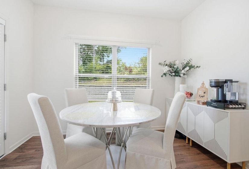 Breakfast Room featuring wood-finish flooring and a window with horizontal blinds