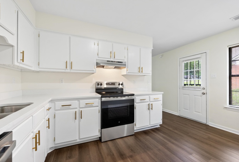 Spacious kitchen with ample cabinet space, updated appliances, and easy access to the backyard and outdoor living areas.