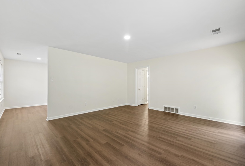 Another view of the large great room highlighting the seamless flow, neutral décor, and move-in-ready condition throughout.