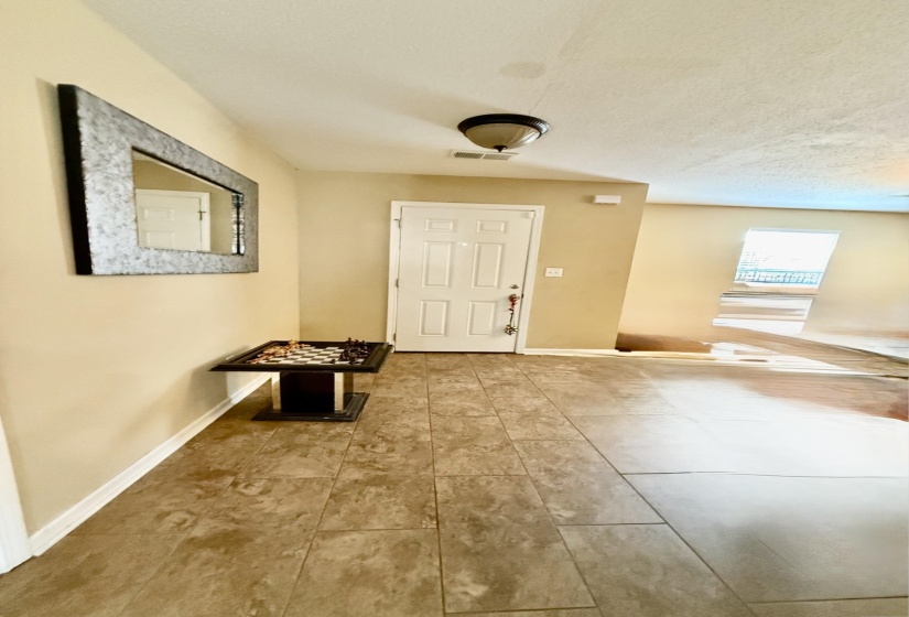 Front entry with light-colored tile flooring