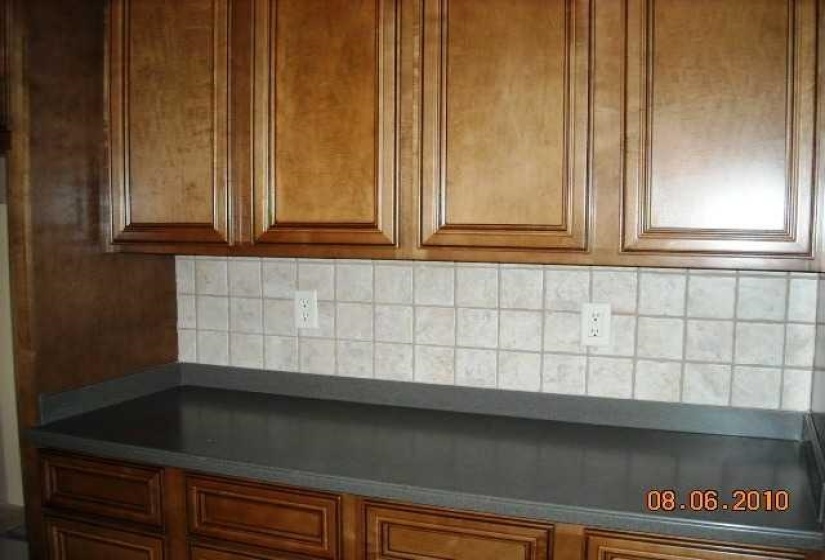 Warm wood cabinetry with raised panel doors