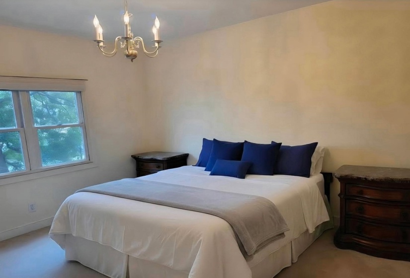 Neutral-toned walls complement a multi-pane window with white trim