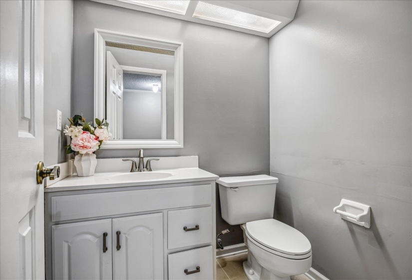 Bathroom vanity with a rectangular undermount sink, a chrome-finish faucet, and a wall-mounted mirror