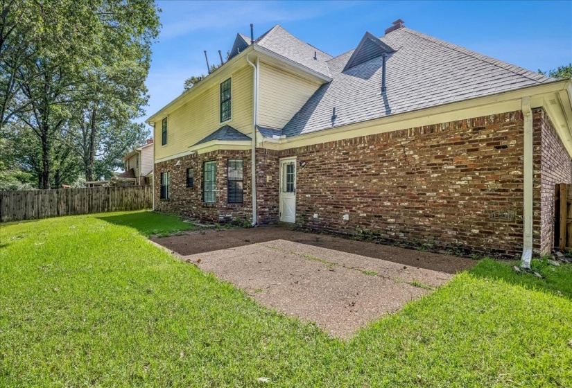 Exterior featuring brick and siding finishes, a gabled roofline, and a concrete patio