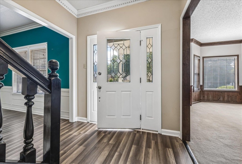 Entryway featuring a decorative transom, sidelights, and leaded glass door