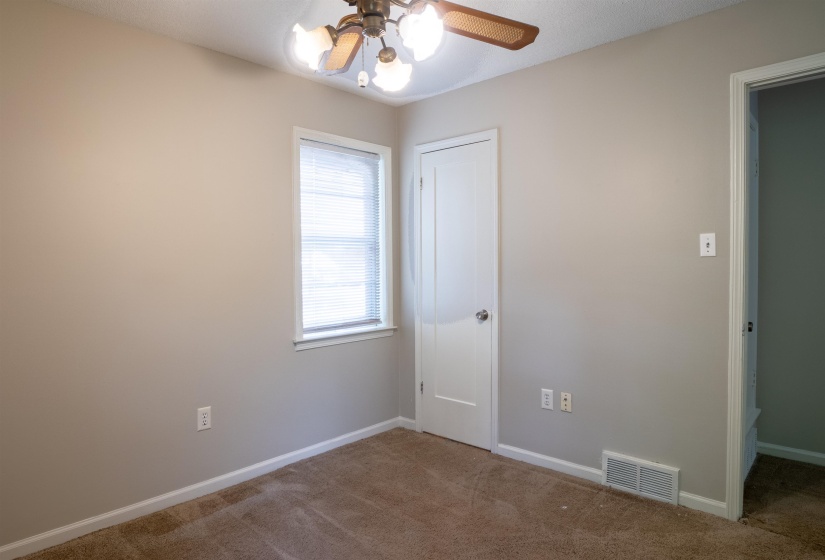Neutral-toned walls complement the brown carpet flooring