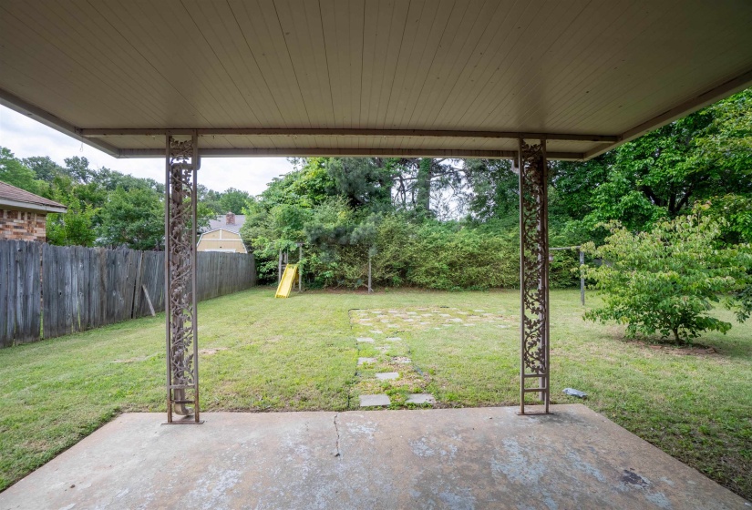 Covered patio featuring concrete flooring and decorative metal support columns