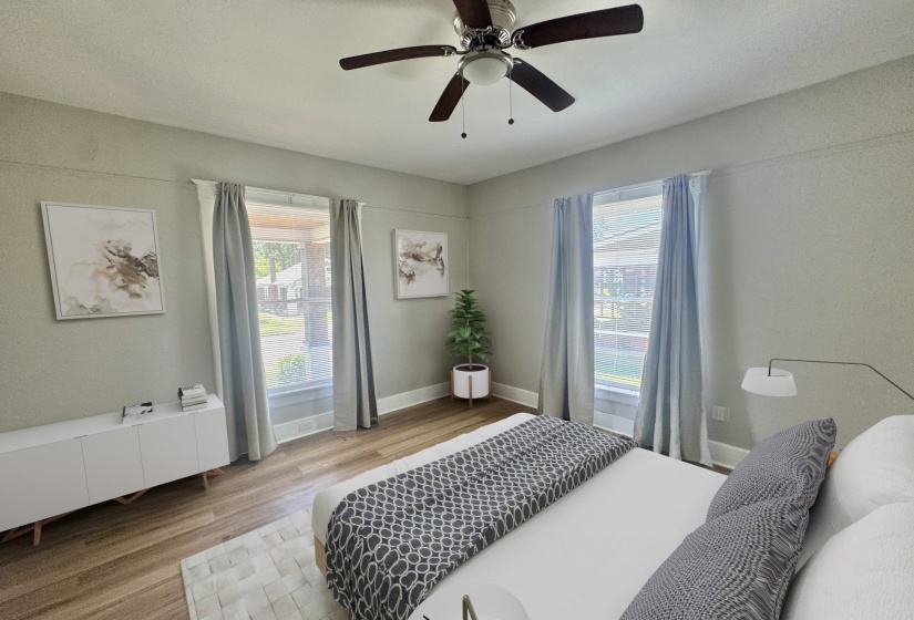 Room featuring wood-finish flooring, a ceiling fan with integrated lighting, and light-toned walls