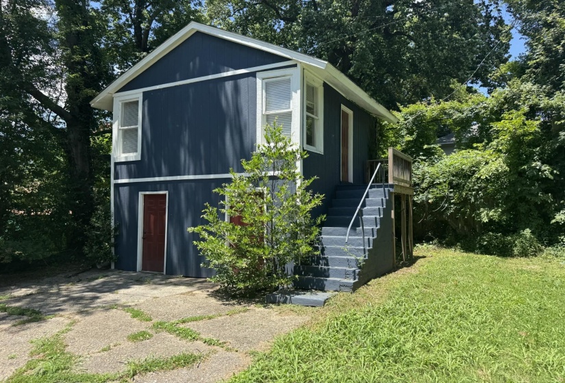 Two-story exterior with dark blue siding and white trim