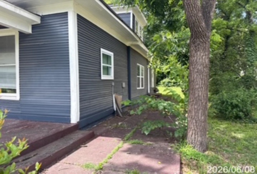 Blue horizontal siding with white trim and white-framed windows