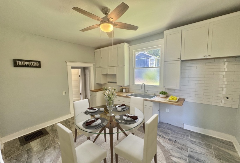 Kitchen featuring white shaker cabinetry, subway tile backsplash, wood-finish countertops, and a stainless steel sink with a gooseneck faucet