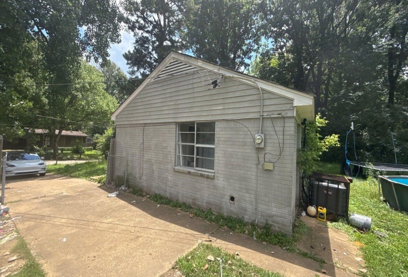 Gray brick exterior with a contrasting light-colored gable and siding