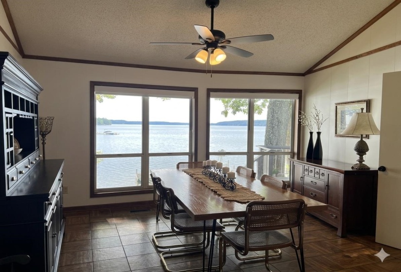 Dining area featuring expansive windows overlooking a body of water