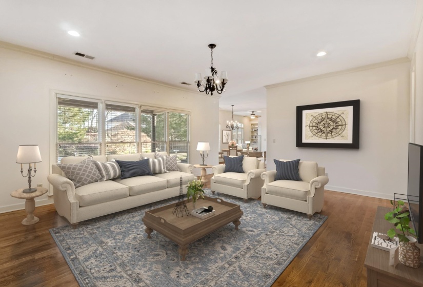 Living area with a chandelier, ornamental molding, recessed lighting, and dark wood-style flooring