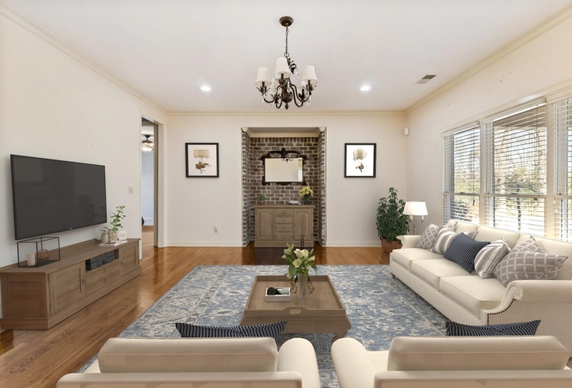 Living area featuring light wood-type flooring, ornamental molding, a chandelier, and recessed lighting
