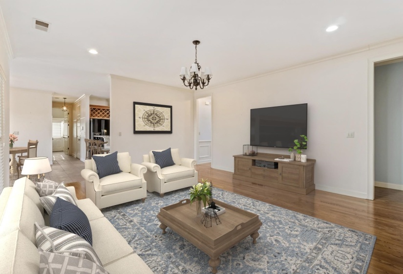 Living room featuring a chandelier, recessed lighting, wood finished floors, and ornamental molding