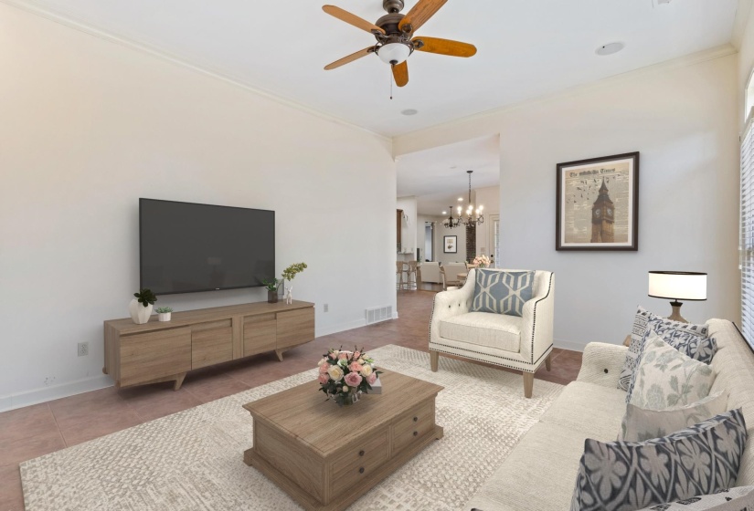 Living room with ceiling fan, a chandelier, and tile patterned flooring