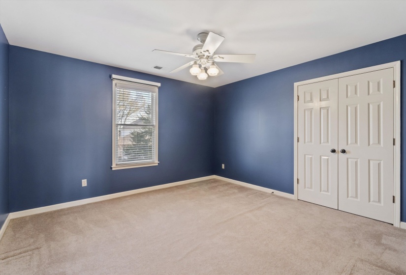 Unfurnished bedroom featuring carpet, a closet, and ceiling fan