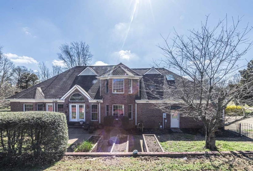 View of front of property featuring brick siding and french doors