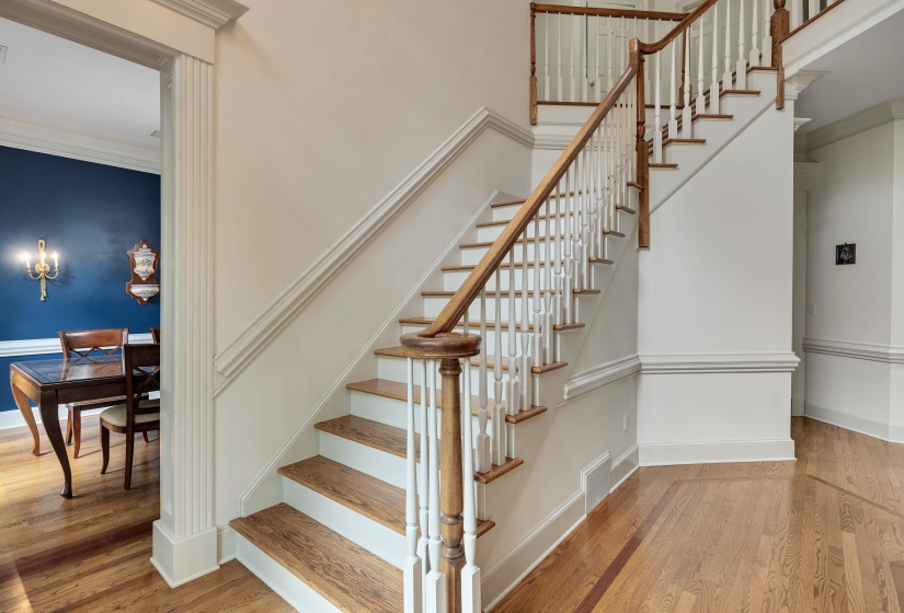 Hardwood staircase featuring white risers and natural wood treads