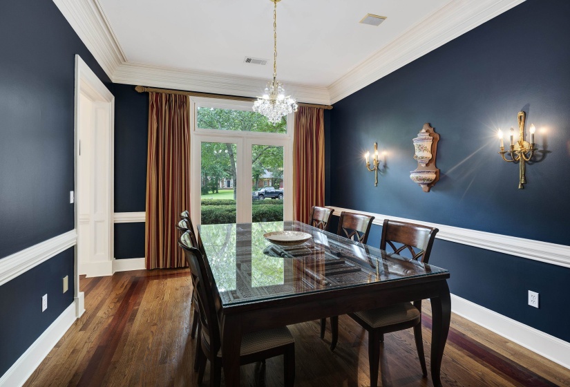 Formal room featuring deep blue walls and wood-finish flooring