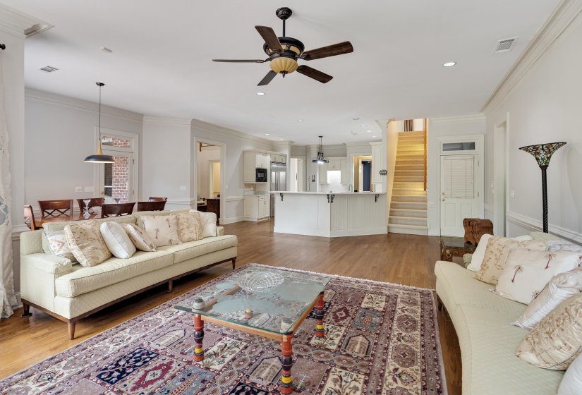 Expansive living area featuring wood-finish flooring, recessed lighting, and a ceiling fan