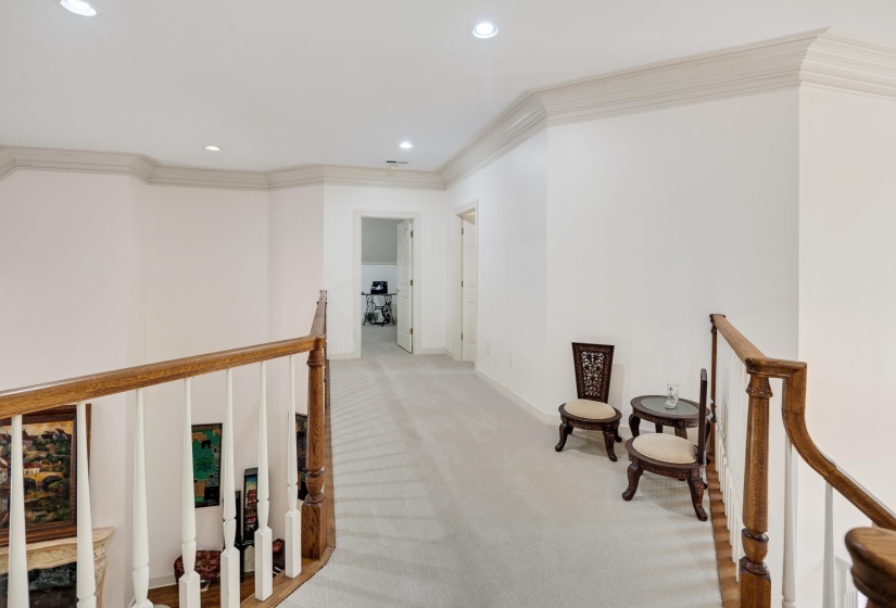 Upper-level hallway featuring light-toned carpet flooring, recessed lighting, and crown molding