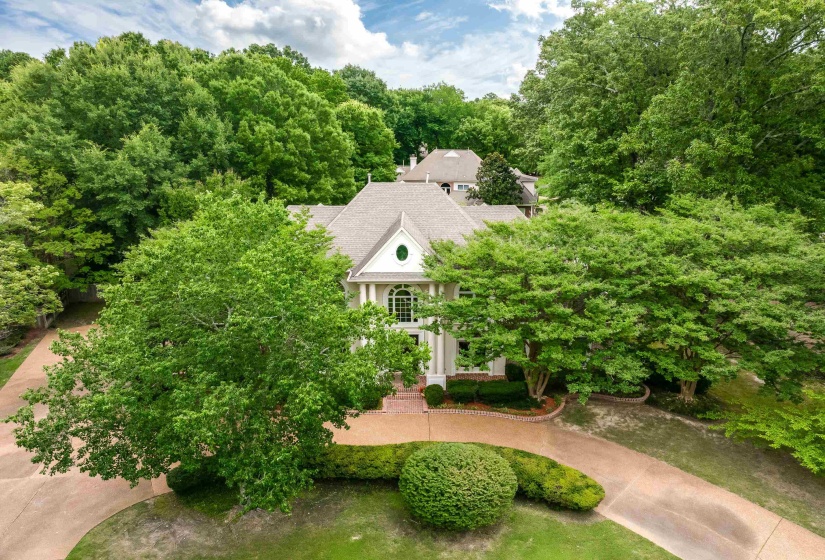Colonial-style residence featuring a prominent gabled roof and a grand entry with columns