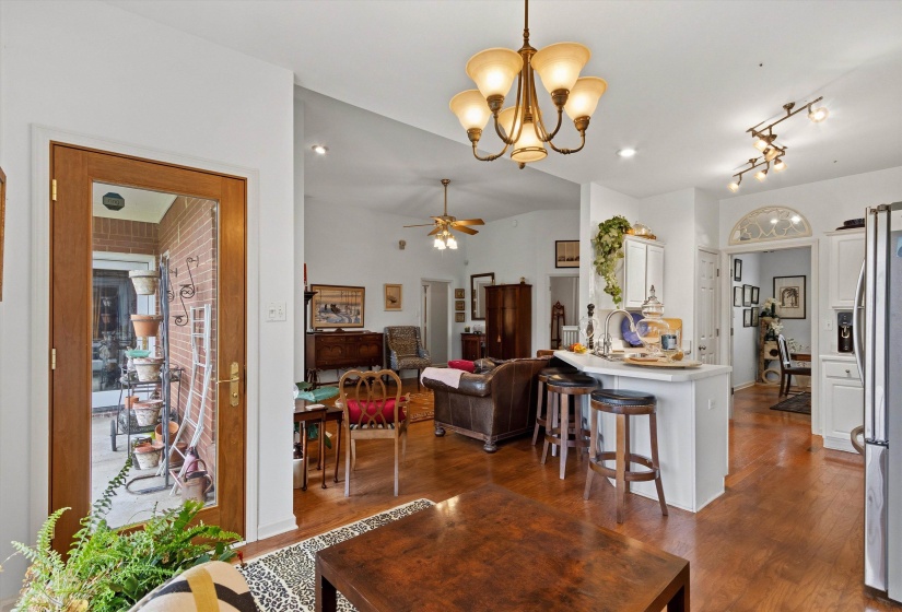 Open-concept living area with wood-finish flooring