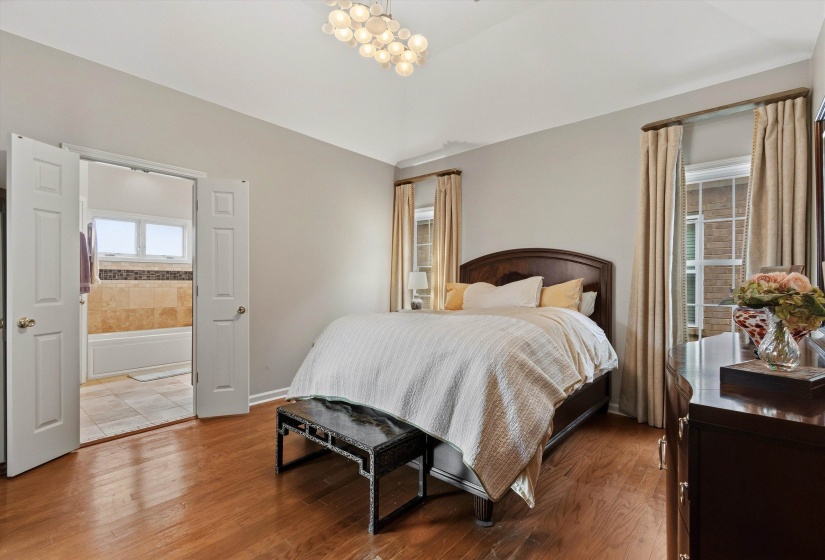 Warm wood-finish flooring complements the neutral wall tones