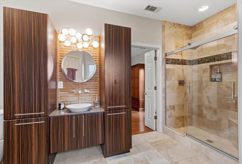 Modern bathroom featuring a glass-enclosed shower with tile surround and built-in niche