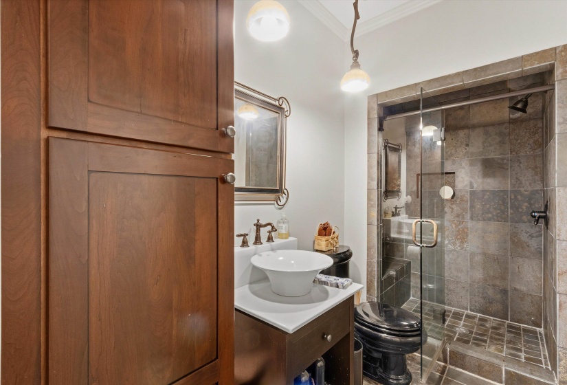 Tiled shower with a clear glass enclosure and dark grout